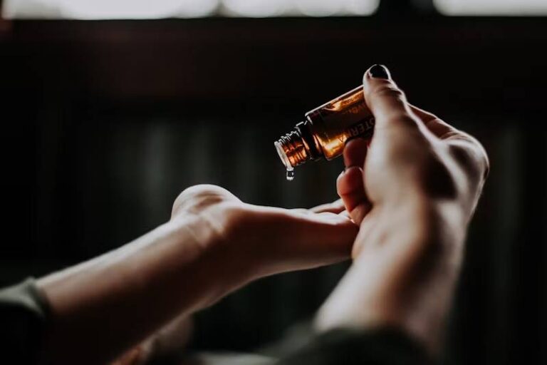 Essential Oils Lab: hand holding a bottle of essential oil Essential Oils Lab: hand holding a bottle of essential oil
